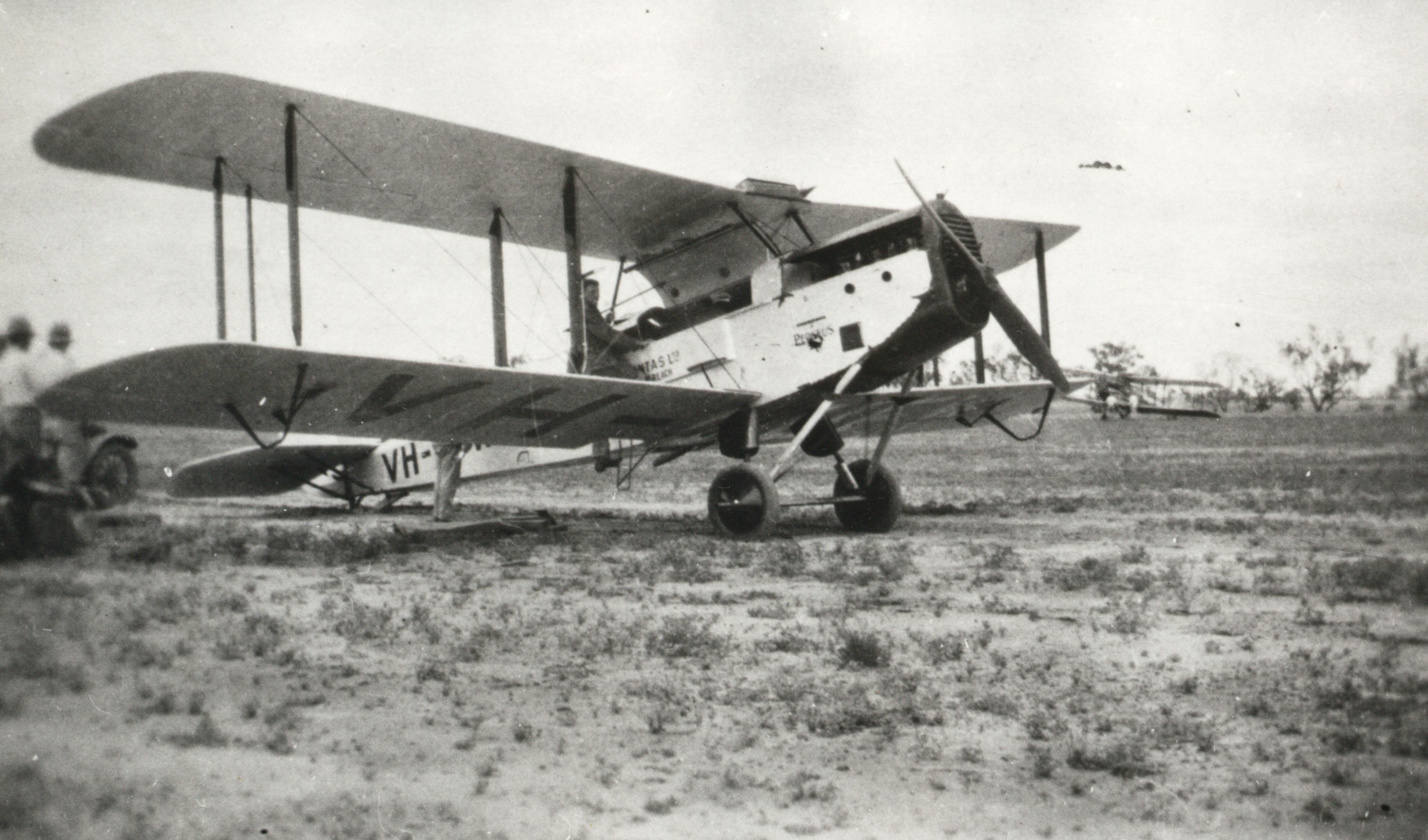 Sir Hudson Fysh in the Qantas airplane 'Perseus' on the Corona Station runway, Queensland, c. 1930 (68-156). Photographer - Thomas Armstrong.