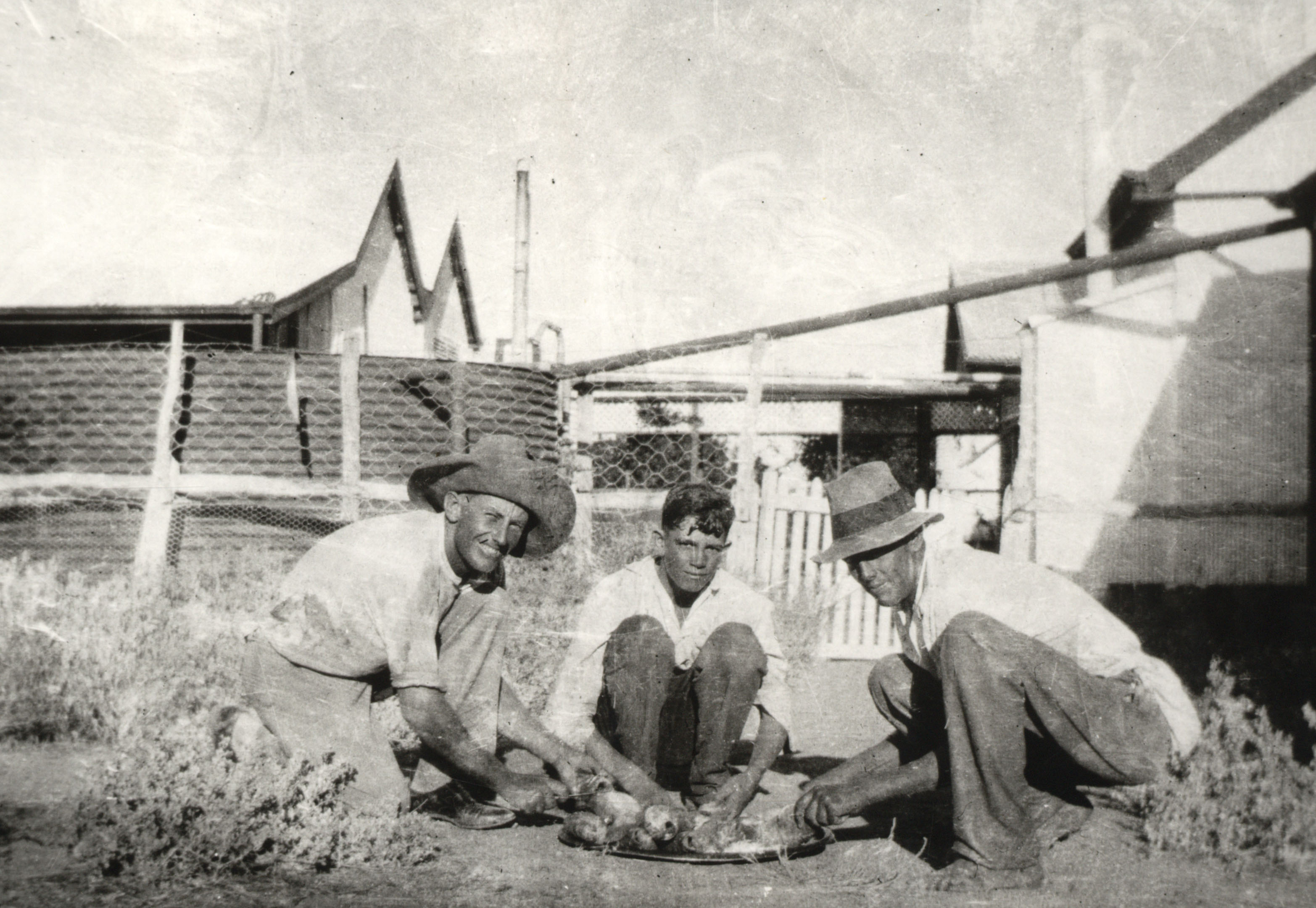 Jackeroos R. McLaren, E. Barton and D McLaren cleaning fish, Corona Station, Queensland, c. 1930 (68-116). 