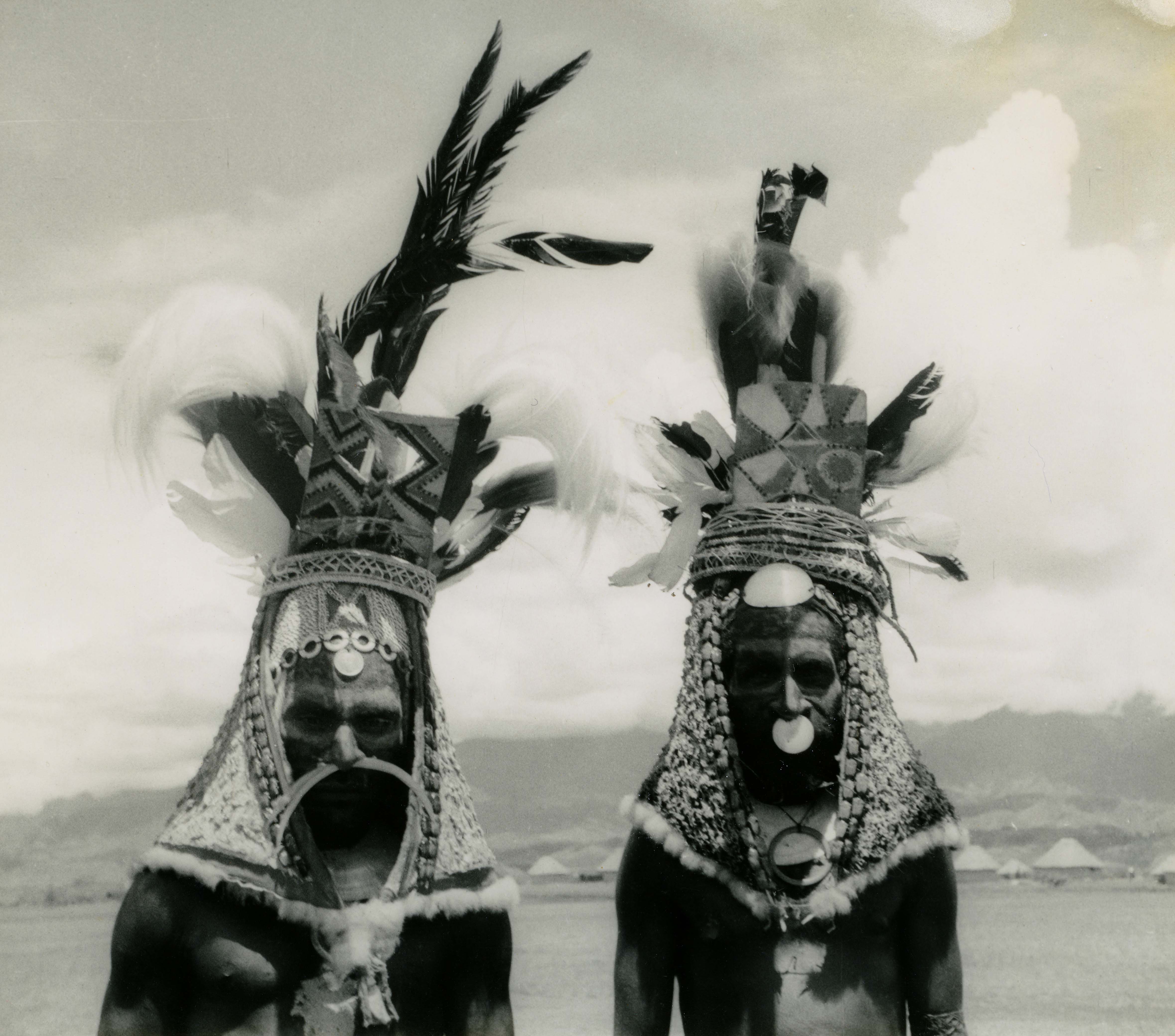 Two Papua New Guinean men in ceremonial headdresses