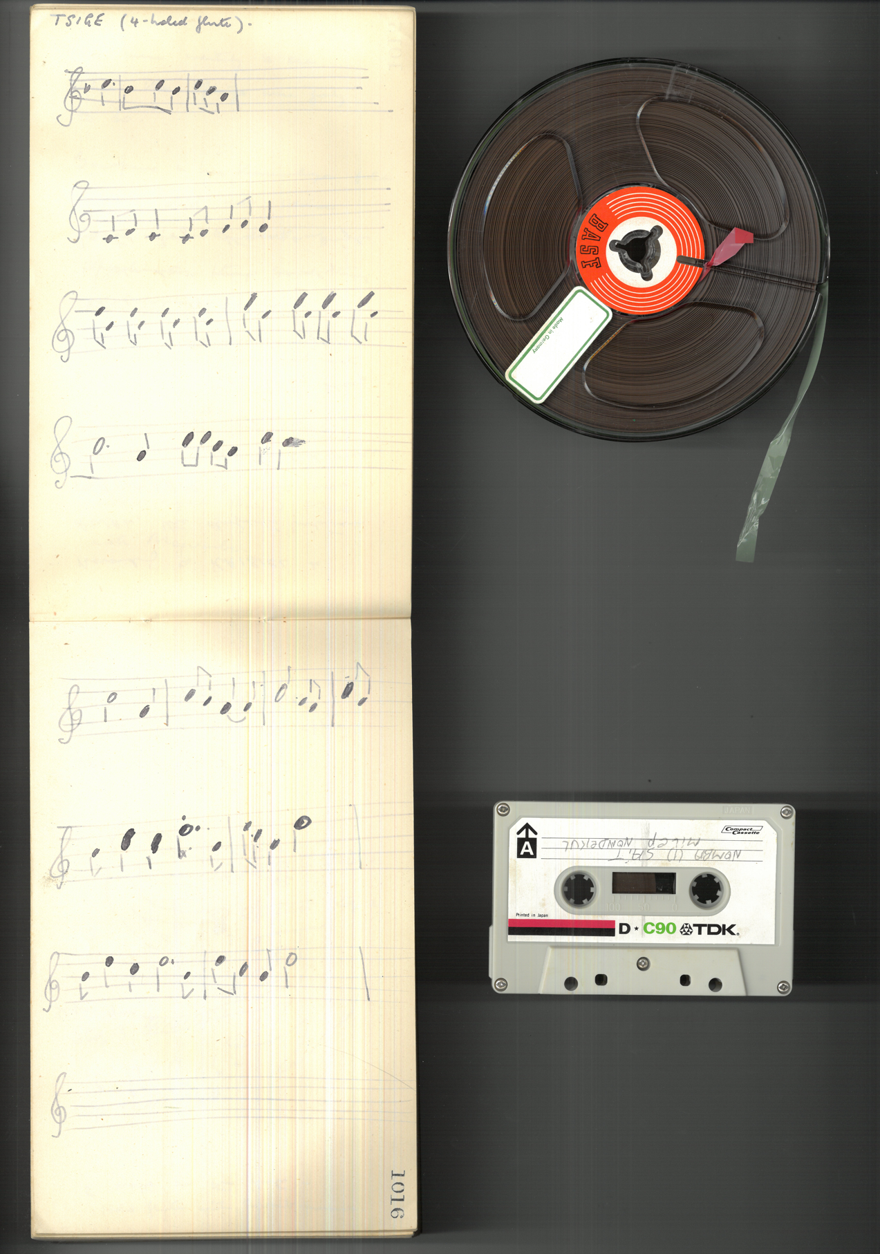 Field notebook with musical notation, sound reel and cassette tape